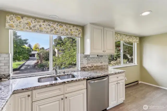 Granite counter tops w/stainless steel appliances in kitchen
