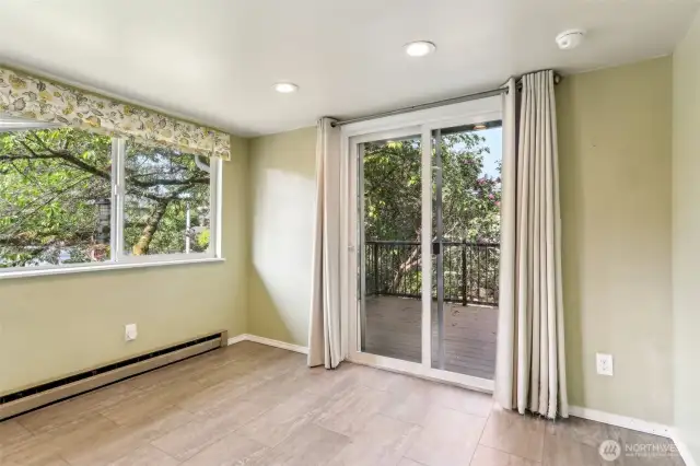 Eating area overlooks wildlife in mature front yard trees; entrance onto brand new composite deck.