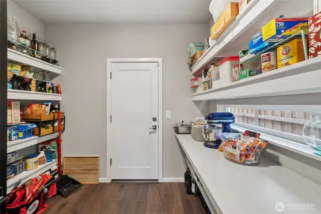 Enormous pantry in between kitchen and garage