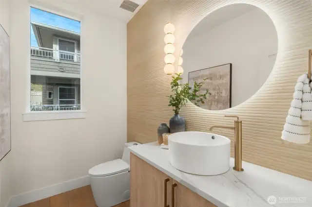 Main-level powder room with modern floating vanity and artistic wall detail.
