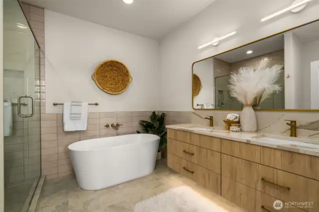 Spa-style full bath featuring double vanity, wood-tone cabinets, and striking tilework—luxury meets functionality for everyday use.