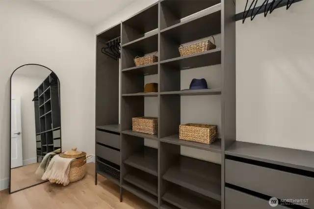 Dream-worthy walk-in closet in the primary suite with custom built-ins, ample hanging space, and thoughtful lighting—organization has never looked this good.