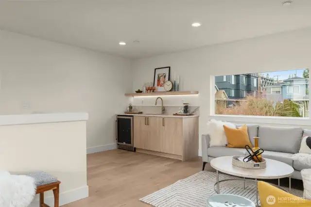 Top-floor bonus room with a wet bar and sliding glass doors leading to the rooftop deck—your future game-day hangout, yoga studio, or cocktail lounge awaits.