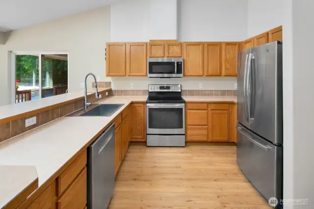 Nice size kitchen with lots of counter space with eating bar and stainless steel appliances.