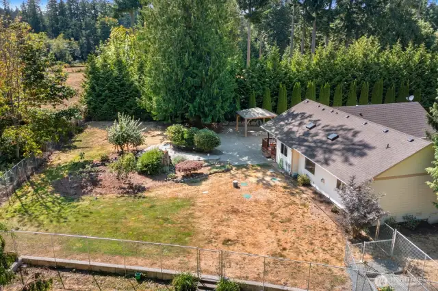 Overview of the fenced in area in the back.