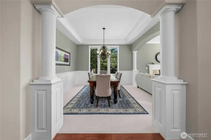 Grand view into the dining area framed by architectural columns, showcasing timeless design.