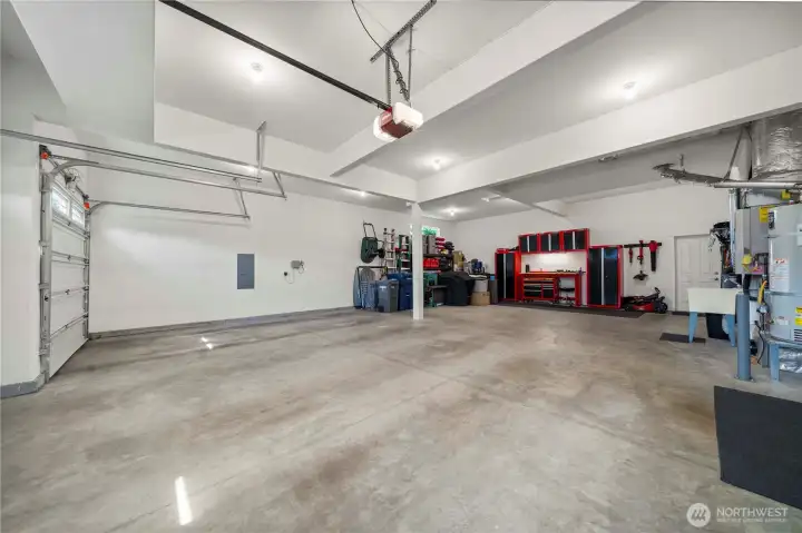Oversized 6-car garage with high ceilings, ideal for vehicles, storage, or a workshop.