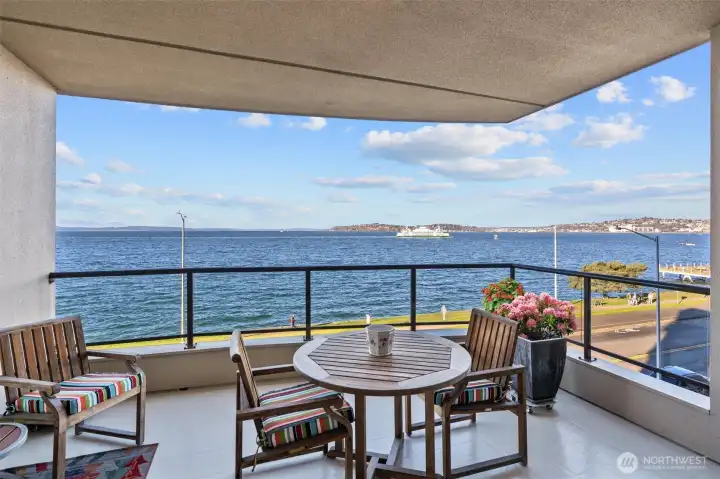 Welcome to Bay Villa! This beautifully appointed 4th-floor condo offers two spacious bedrooms plus a versatile home office/media room. Enjoy the convenience of two prime parking spaces, including one with EV charging. The expansive, view-facing primary suite showcases sweeping vistas of the Olympic Mountains, the Space Needle, and Puget Sound, creating a stunning backdrop for everyday living.