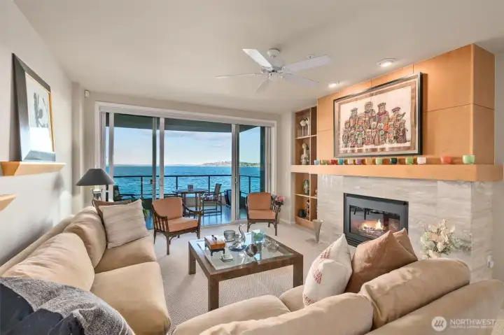 The living room offers double sliding doors leading to a large view lanai and is anchored by a warm, inviting gas fireplace.