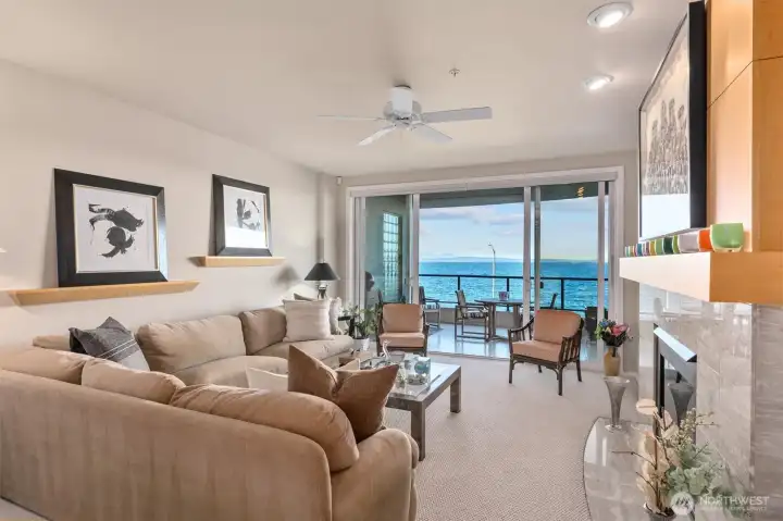 The living room is an ideal space for entertaining, where you can enjoy the constant parade of marine life, ferries, herons, and eagles passing by.
