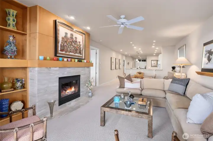An open view into the living room, with the primary suite to the left and the kitchen beyond, creating an easy, flowing layout.