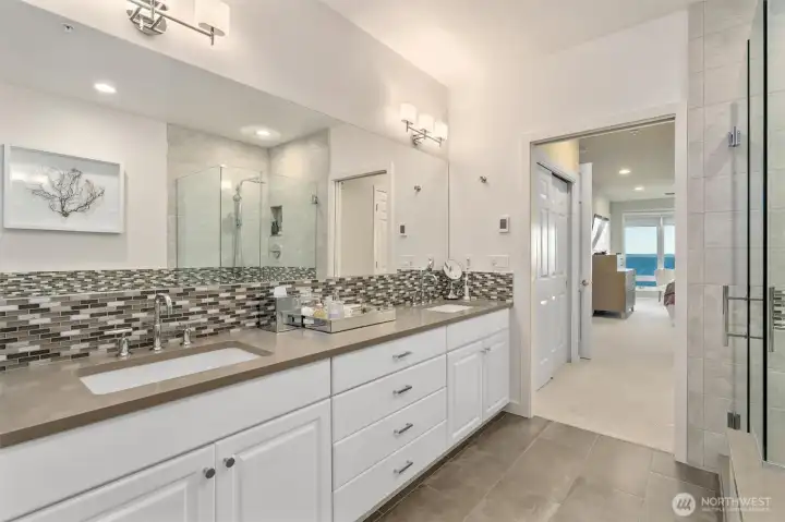 The updated five-piece Primary bathroom offers a spa-like retreat, complete with heated floors and calming, soothing colors.