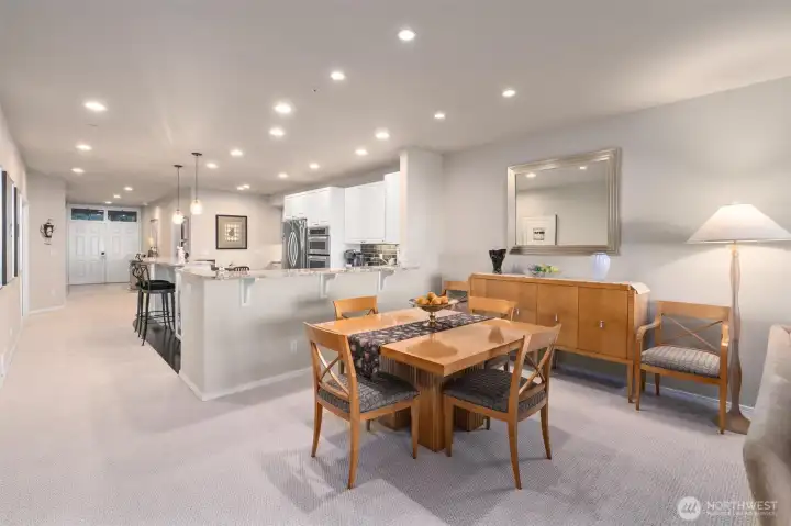 Living room to the right, dining area in the foreground and kitchen to the left.