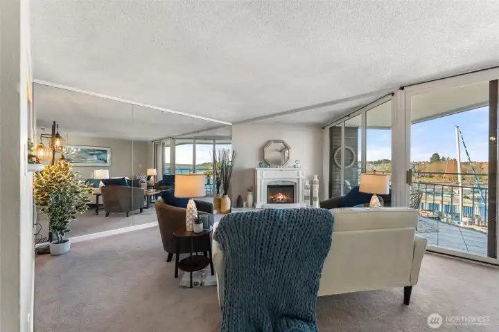 Spacious living room with floor-to-ceiling windows framing the marina and filling the home with natural light.