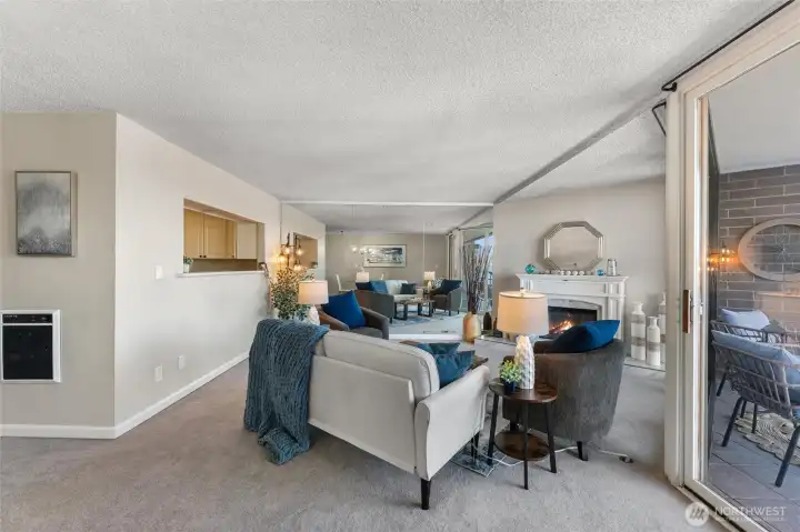 Open living and dining layout showcasing indoor-outdoor flow and panoramic marina scenery.