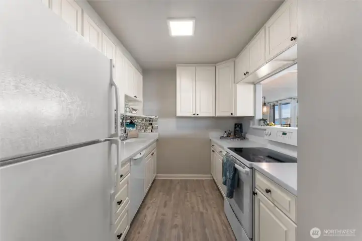 Updated kitchen with white cabinetry, ample storage, and efficient design for everyday living.