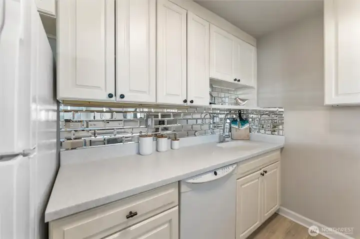 Bright kitchen workspace with tile backsplash, generous counter space, and modern finishes.