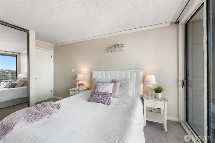 Primary bedroom retreat with sliding glass doors and tranquil marina outlooks.