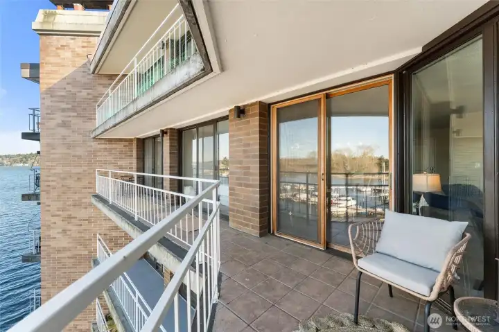 Covered balcony space offering year-round enjoyment and unobstructed water views.