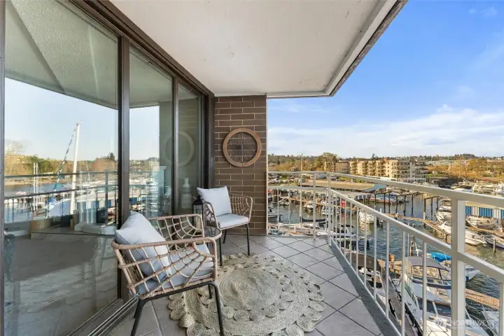 Outdoor seating area designed for relaxation while watching boats glide through the bay.