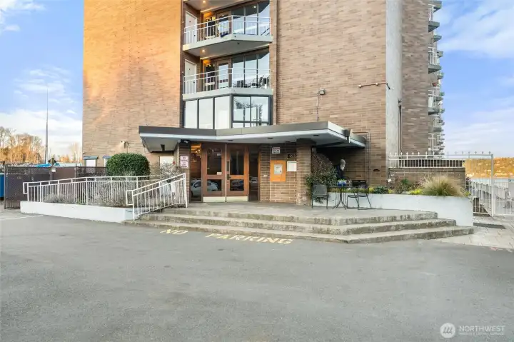 Building exterior and entry showcasing waterfront access and well-maintained grounds.