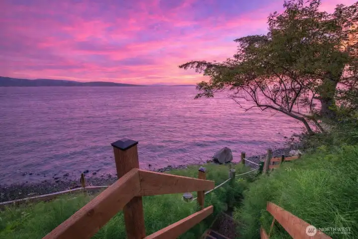 Newly installed treated wood steps provide direct access to over 100 feet of private pebble beach.