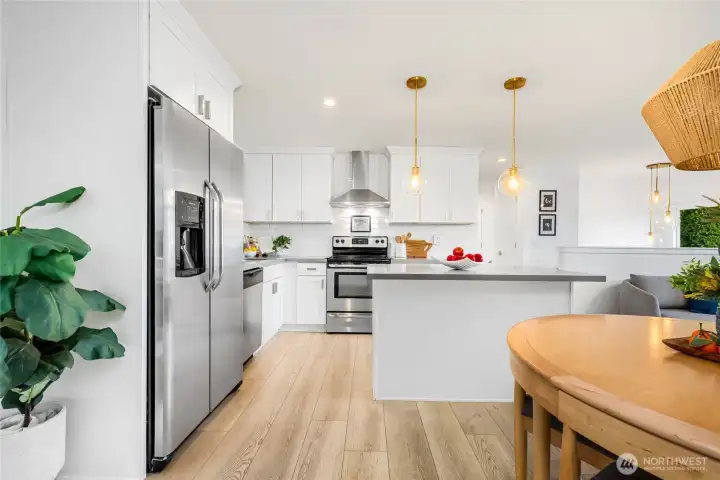 Designer kitchen with quartz counters and matching stainless appliances