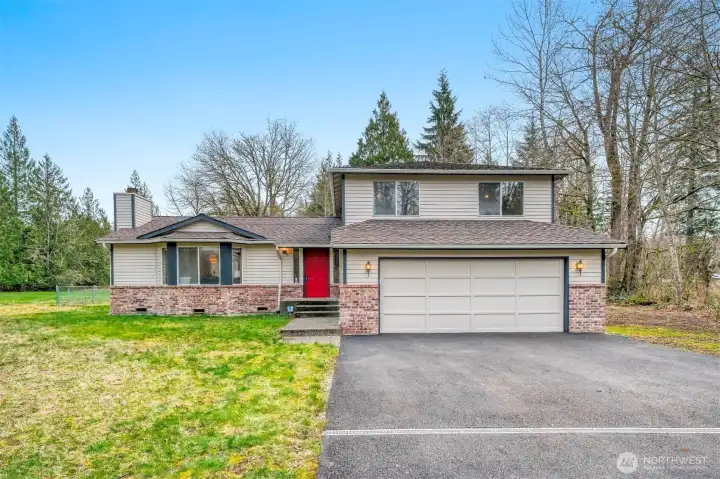 Classic tri-level architecture blends modern lines with natural surroundings.