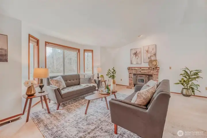 Spacious living room highlighted by vaulted ceilings.
