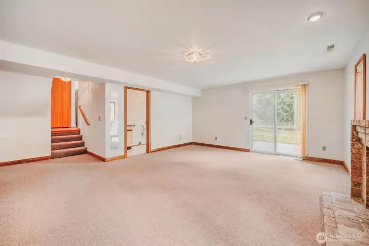 Spacious lower-level family or bonus room. Adjacent bathroom adds convenience.
