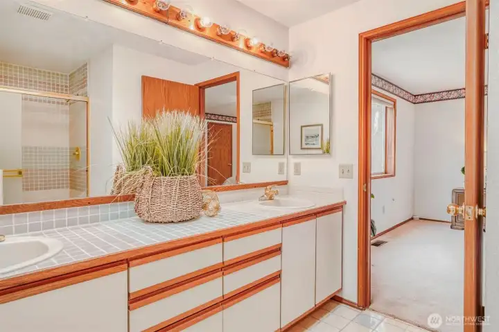 Another view of the primary bath with a dual sink vanity.