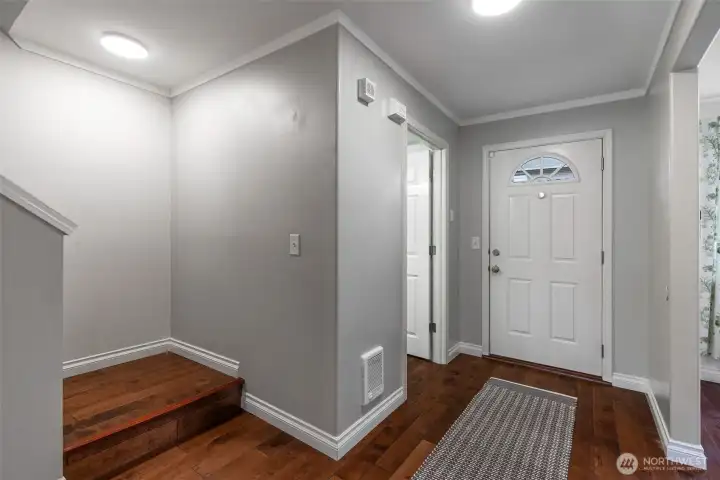 1/2 bathroom and laundry off of the front entrance. Stairs up to second floor.