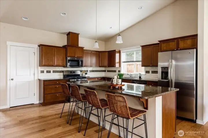 Kitchen with granite countertops + stainless appliances