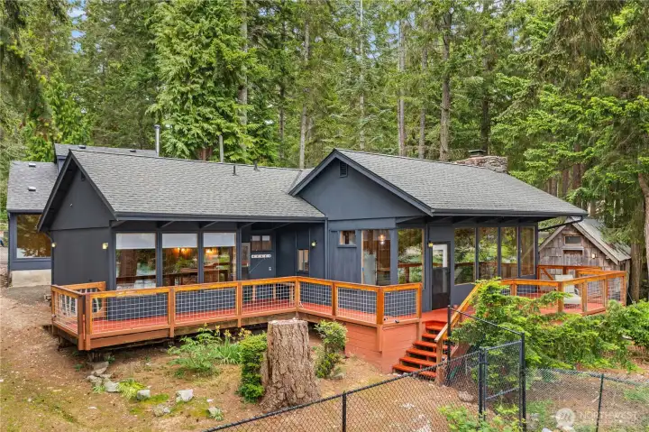 This unique property offers two separate living spaces along with a separate powered workspace and storage by the water.