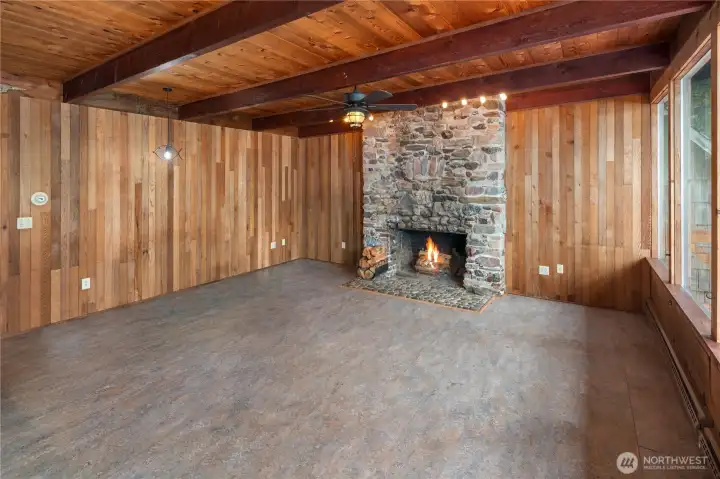 The stunning fireplace tells a story of adventure, built from rocks gathered during travels and thoughtfully incorporated into the home’s design.