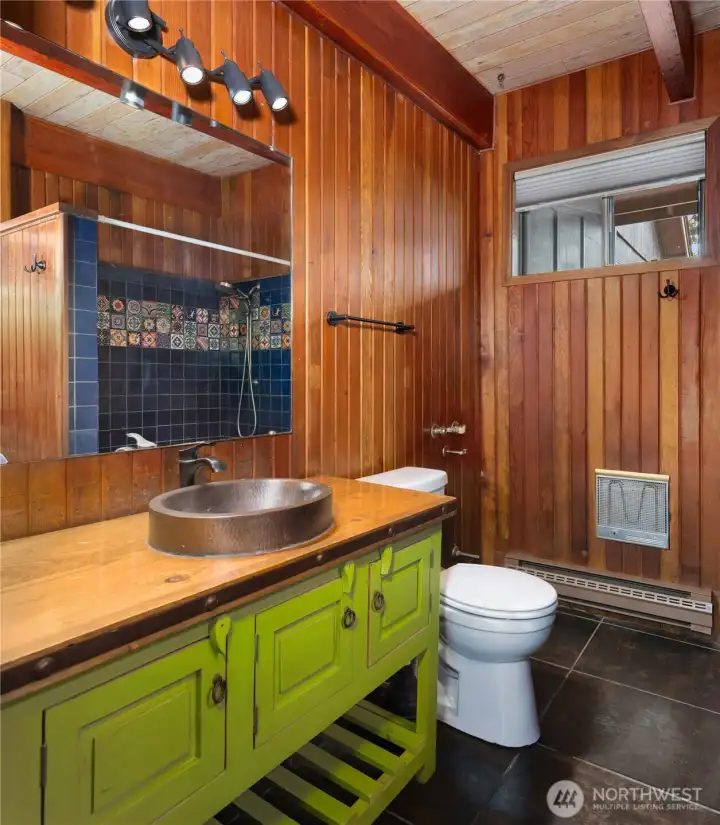 Charming main house 3/4 bath with rustic cabin-inspired character.
