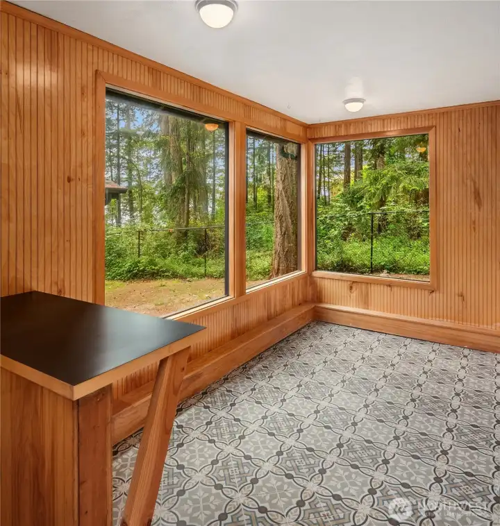 Detached home living room enhanced by expansive windows.