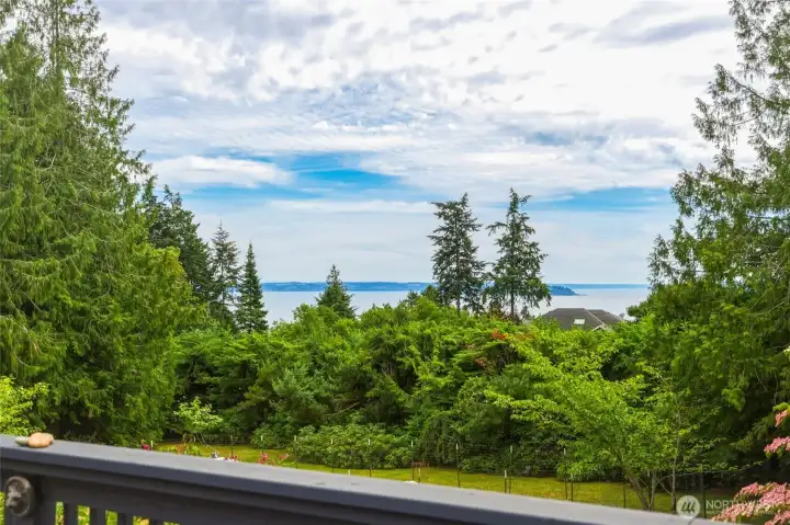 View of the sound and Mount Rainier from the main level deck off of the dining room. View of the sound and Mount Rainier from the main level deck off of the dining room.