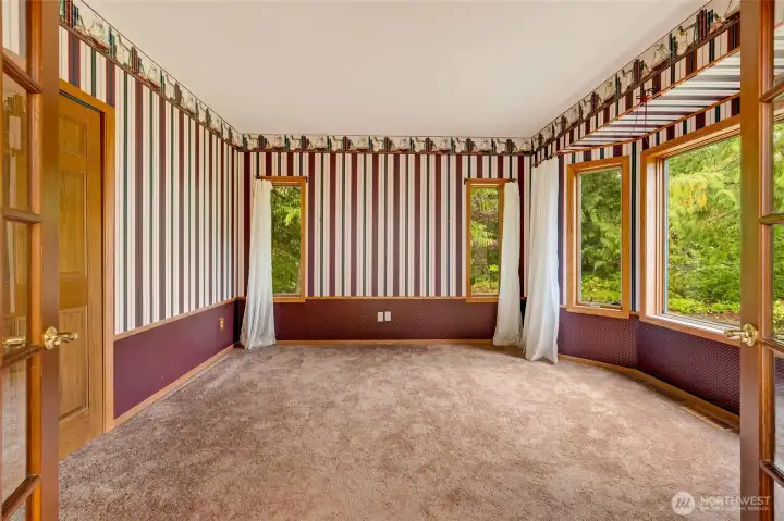 Secondary bedroom/study with double French doors on the main level. Secondary bedroom/study with double French doors on the main level.