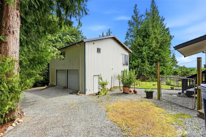 Large two story shop with driveway that leads around to the other side of the property. Large two story shop with driveway that leads around to the other side of the property.