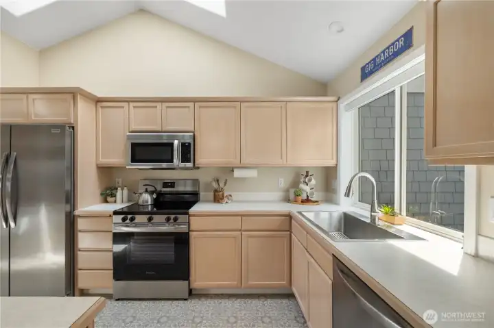 Vaulted ceilings continue into the kitchen where you have a large window above the sink. Vaulted ceilings continue into the kitchen where you have a large window above the sink.
