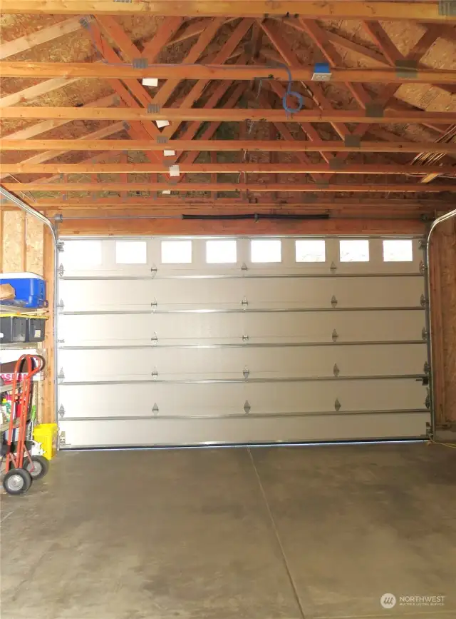 THE DOUBE CAR GARAGE HAS A NINE FOOT DOOR AND IS OVERSIZE FOR THR HANDYMAN TO BUILD A WORK BENCH IF THEY DESIRE!