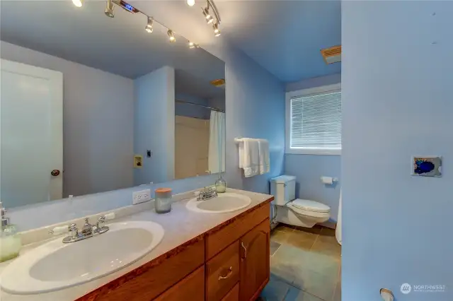 Another convenient, Full Bathroom on the upper level also encompasses a washer and dryer hook-up.