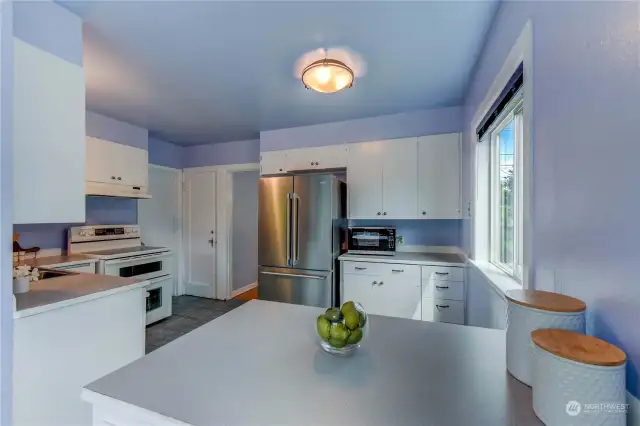 Kitchen boasts a brand new, high-end, stainless refrigerator and lots of space.