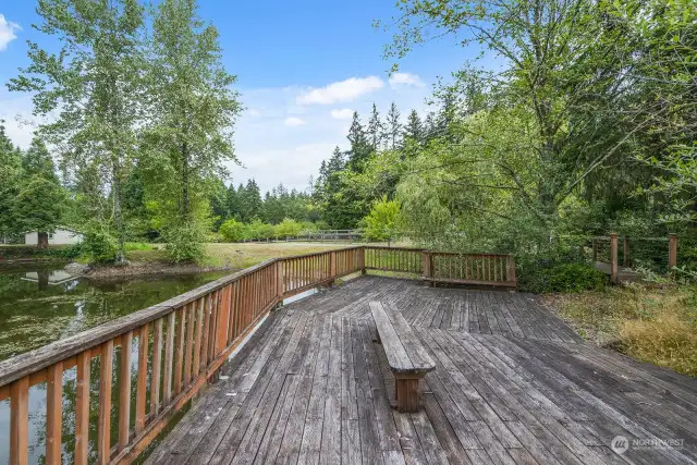 Huge Deck with Stairs leading to a waterside landing.