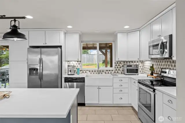 Stainless steel appliances, penny tile backsplash, under cabinet lighting, memorable hardware & fixtures.