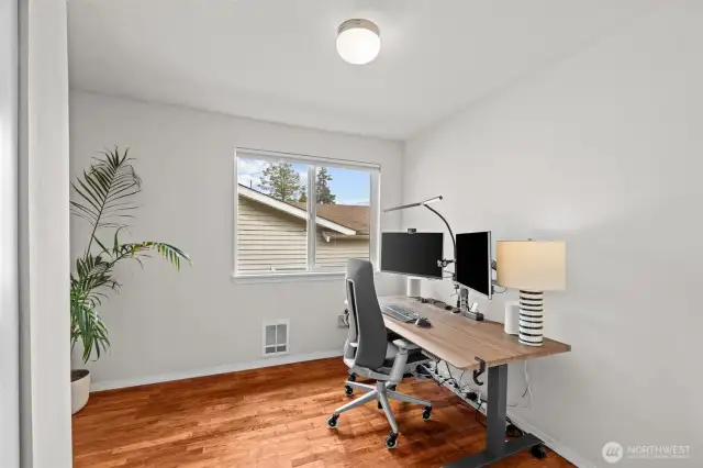Upper level bedroom 2. Use as a bedroom or office. Window towards side yard.