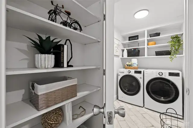 Laundry off lower level hallway with shelving design niche.