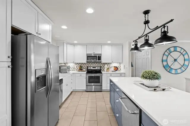Chic, updated kitchen with soft closing cabinets, island seating and beverage fridg