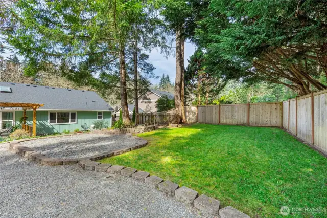 Large level grassy play area within the fully-fenced backyard